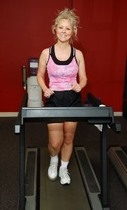 Woman Running on Treadmill in Gym